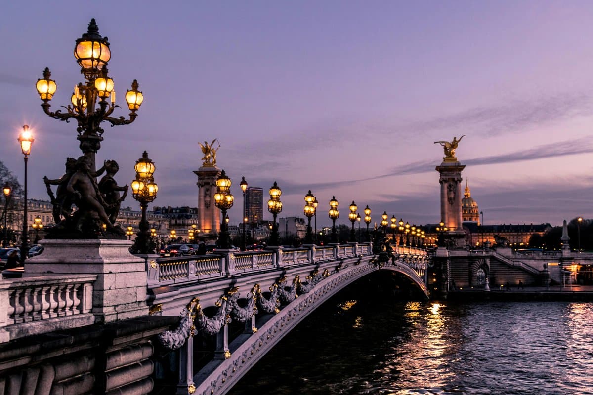 Paris riverside at dusk with its lamps lit, one of many tours to pick from