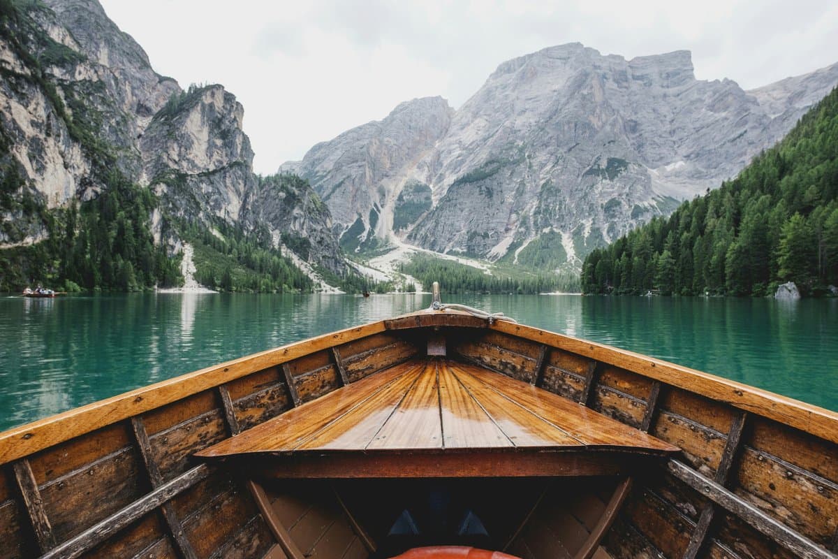 Boat on a still mountain lake, the guide turning the camera on request